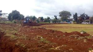 Alat berat meratakan lapangan sepak bola Perum Suradita, Cisauk, Kabupaten Tangerang.